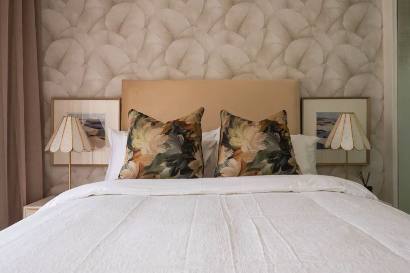 Raffinato Property Group Bedroom Project - Luxury contemporary bedroom styling with integrated pastel green layers, modern upholstery headboard, and cozy linen layers.